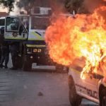 A-South-African-police-van-is-set-on-fire-following-protests