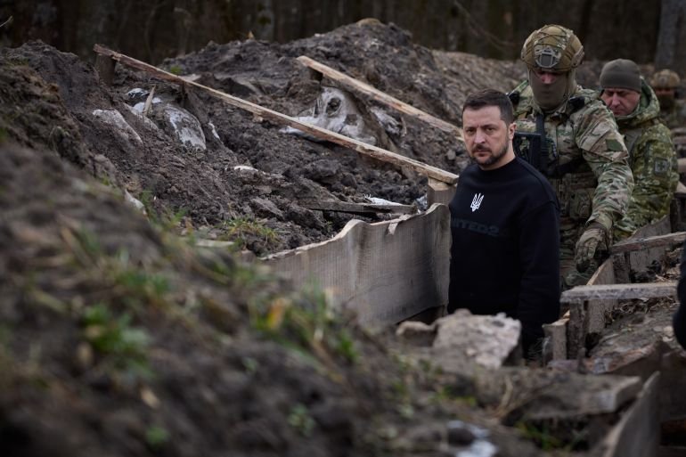Ukraines President Volodymyr Zelenskyy walking along trenches